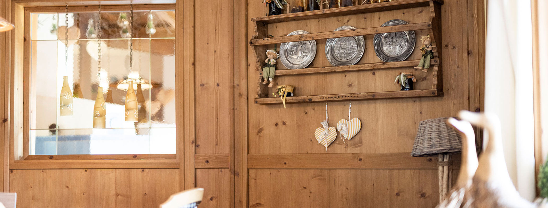 Dekorationen an der Holzfassade der Stube - Hotel Baumwirt